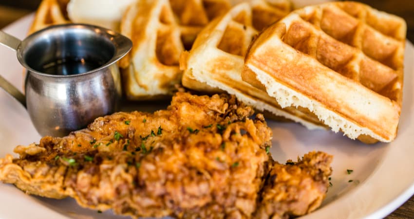 fried chicken and waffles on a plate with syrup