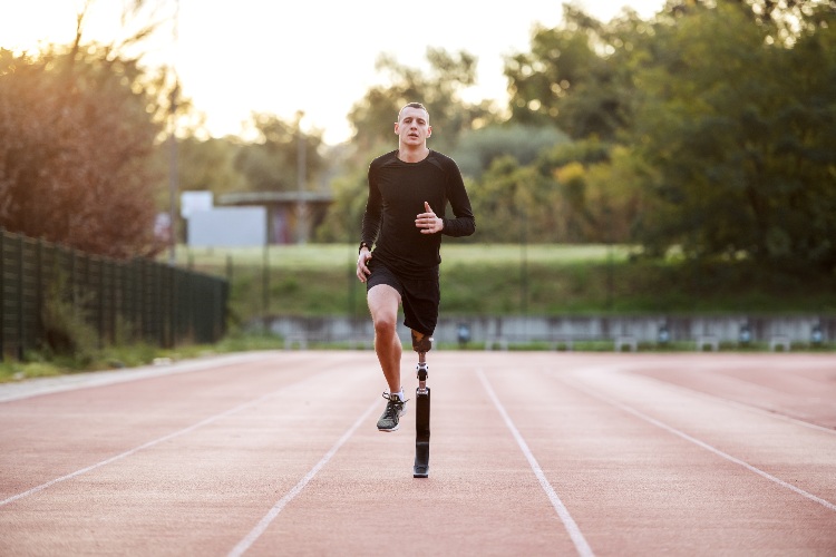 Image of man with prosthetic left leg running on a track