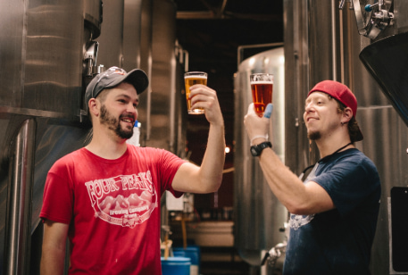 two beer fans sample craft beer in a brewery