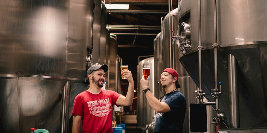 two beer fans sample craft beer in a brewery