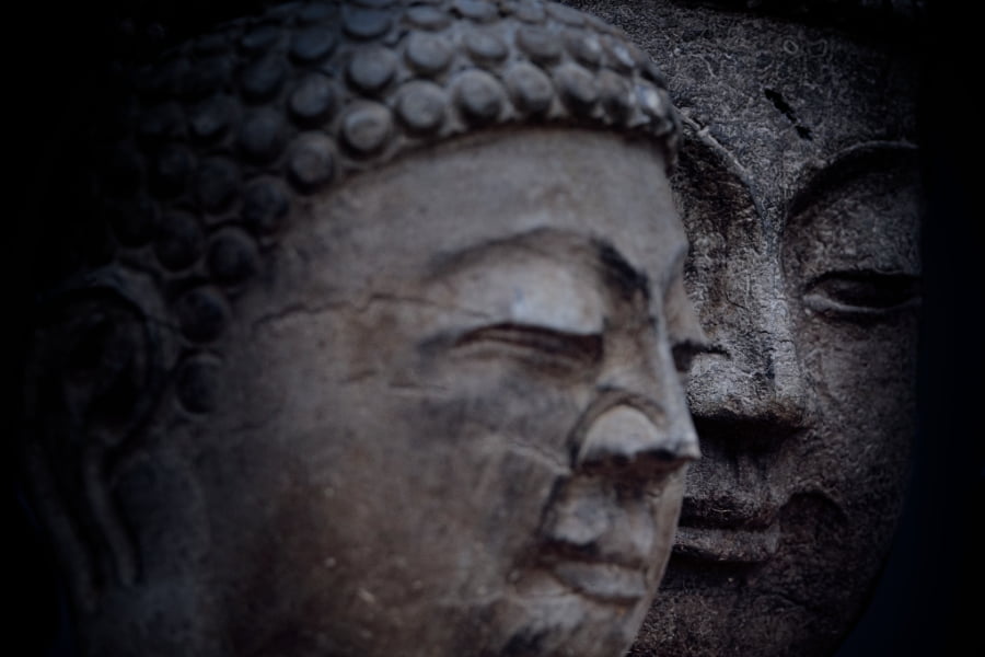 closeup of two Buddha statue faces