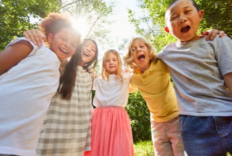 A group of children smiling on a field trip