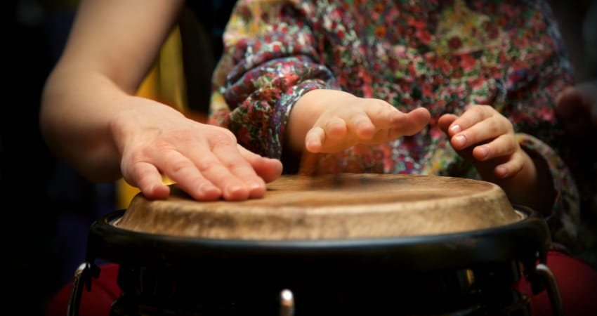 a mother and child play the drums together