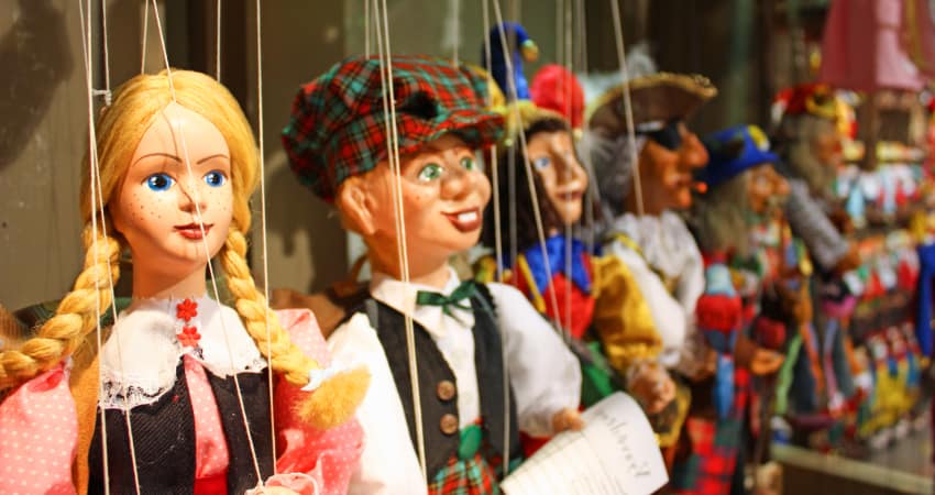 a lineup of puppets in a theatre