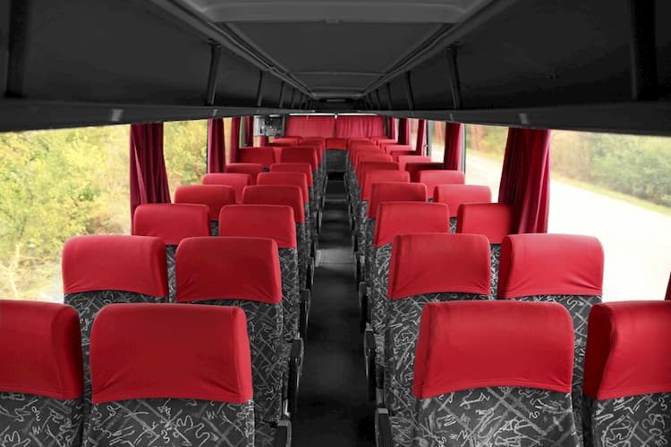 Charter bus interior with gray and red seats