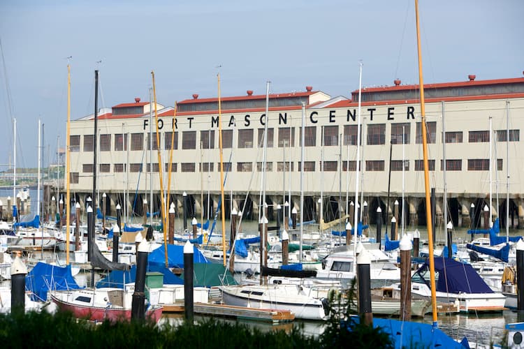 The Fort Mason Center building from the outside with boats in front of it