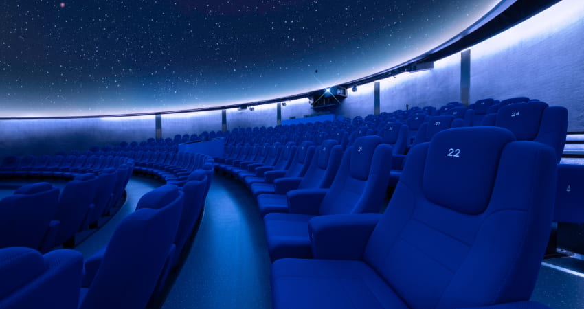 interior of a planetarium, stars projected on the cieling