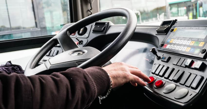 A close up of a charter bus driver's hands