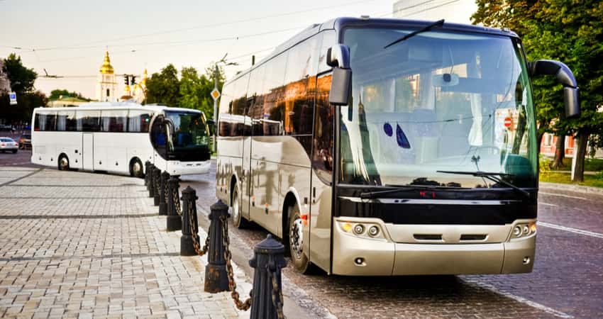 Two charter buses on the road