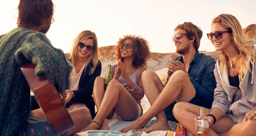 A group of friends sitting on the beach