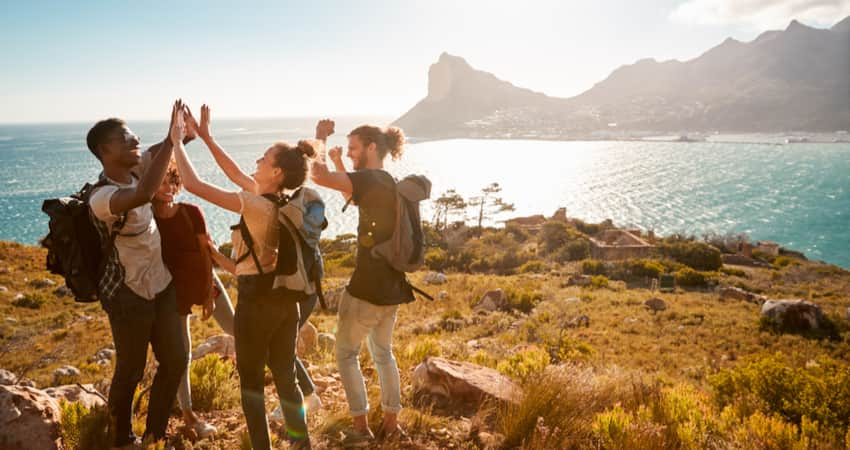 A group of friends hiking by the water on the West Coast