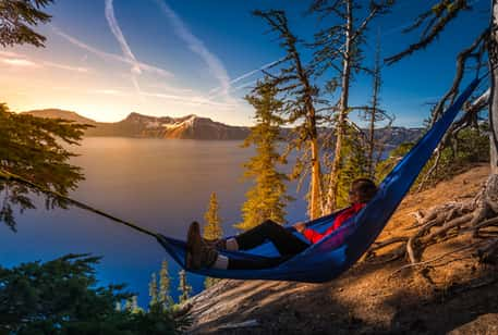 A hiker in a hammock overlooking the lake at Crater Lake National Park