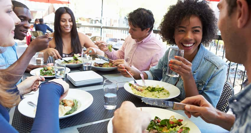 A group of friends dining outside on a patio