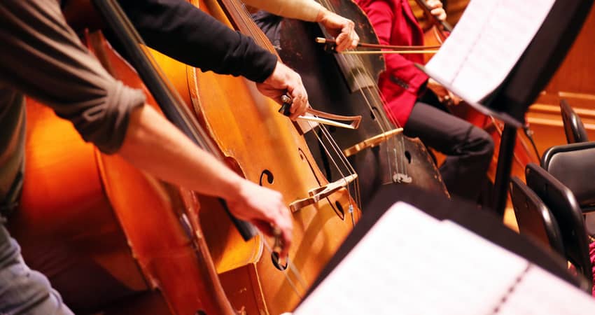 Close up of an orchestra playing instruments