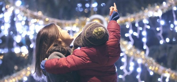 mother and child enjoying holiday lights