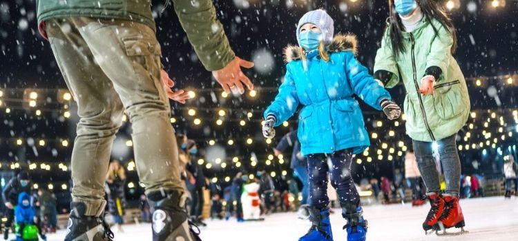 families enjoying holiday ice skating