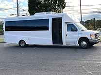 a white minibus parked in a parking lot